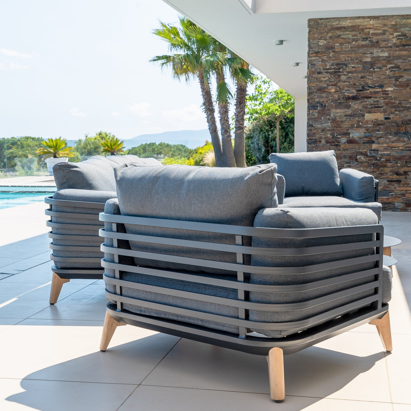 Fauteuil de jardin Monte Carlo Meublot en rotin naturel, avec coussin beige, idéal pour l'extérieur, vue en extérieur.