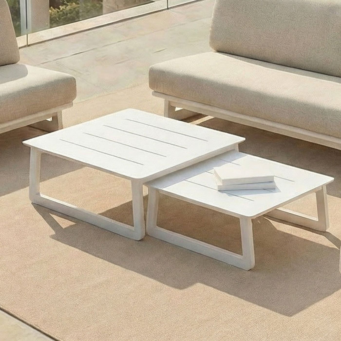 Deux petites tables blanches du salon de jardin Long Beach 7 places de la marque Meublot, idéales pour un espace extérieur élégant.