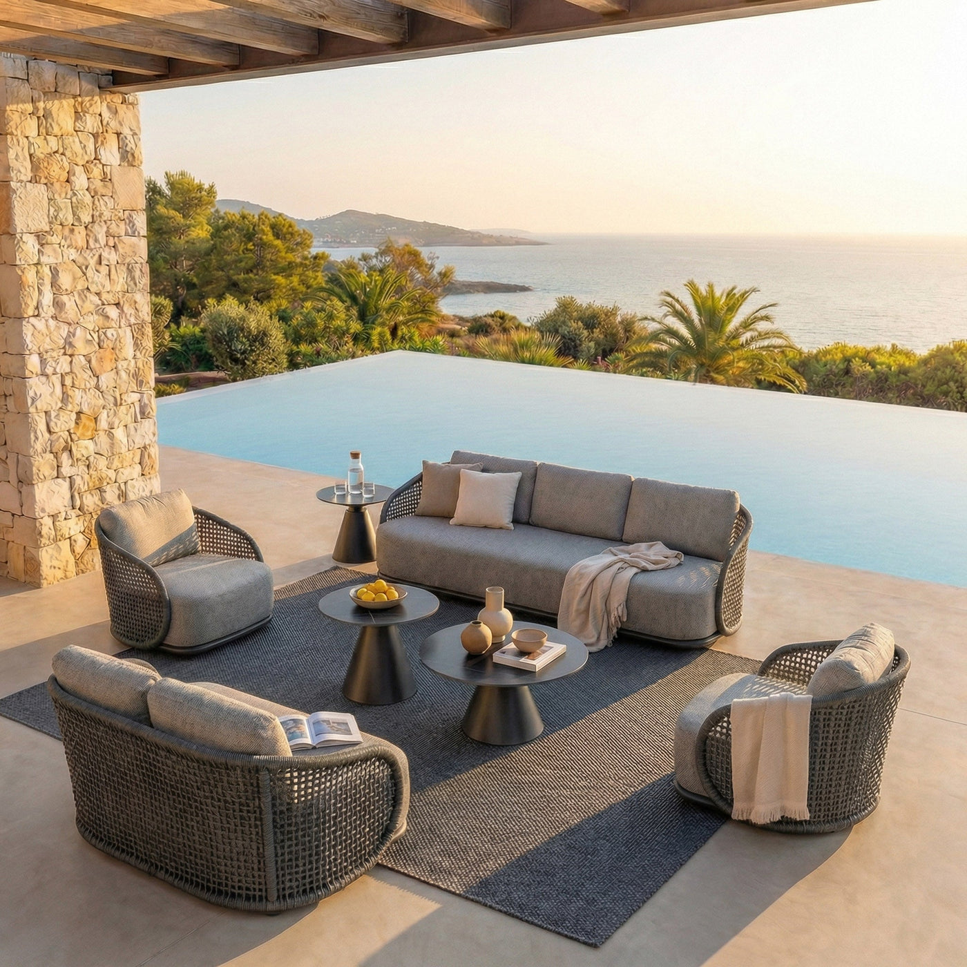 Salon de jardin Riviera 7 places de Meublot avec fauteuils anthracite et table, idéal pour l'extérieur, en fin de journée.