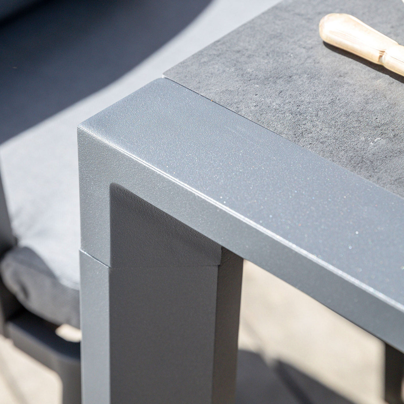 Table de jardin extensible Meublot Amalfi en aluminium gris anthracite, vue de face avec détails de la surface.